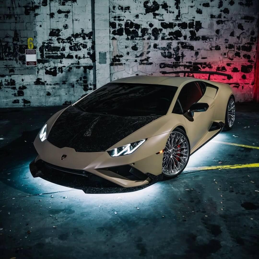 lamborghini sports car in a dark, urban setting with graffiti-covered walls with underbody lights/underglow RGB