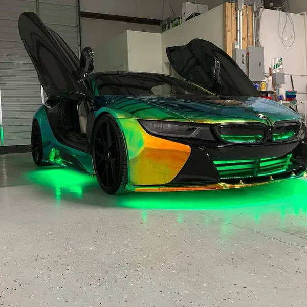 Futuristic bmw i8 car with open doors in a garage setting with green under-body RGB lights/underglow fast and furious lights