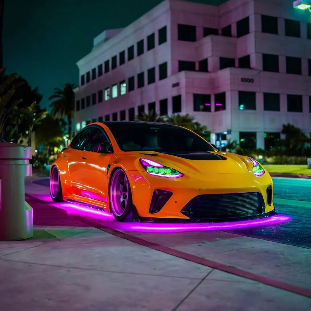 Orange sports car with neon lights on a city street at night