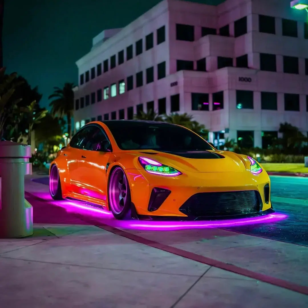 Orange sports car with neon lights on a city street at night
