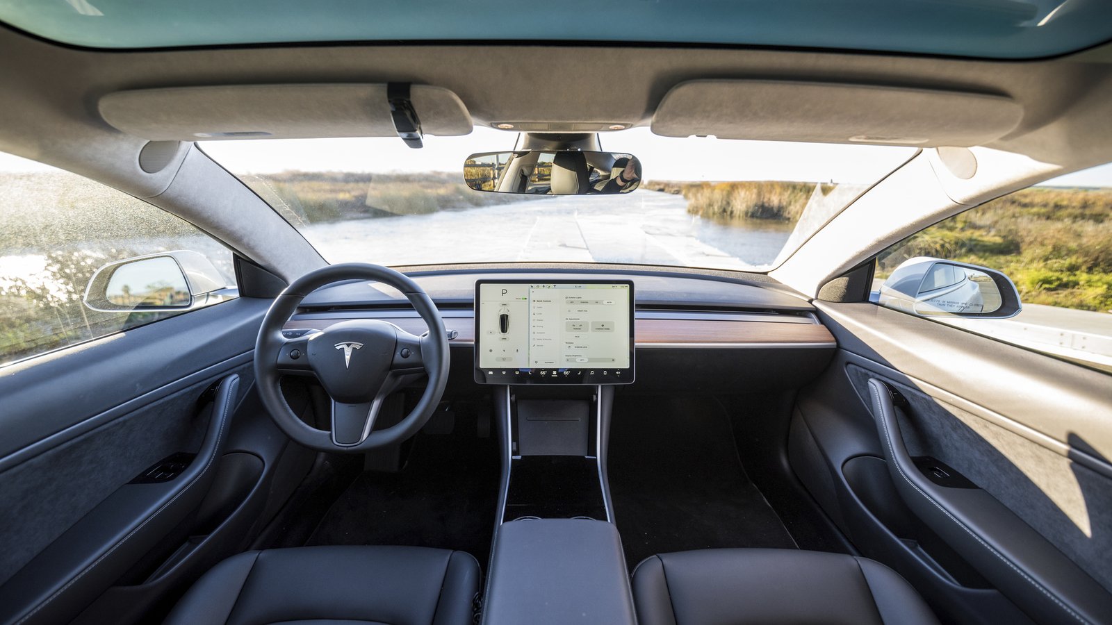 Tesla Model 3 minimalist interior with dashboard, center screen, and door panels, the canvas for an ambient lighting upgrade