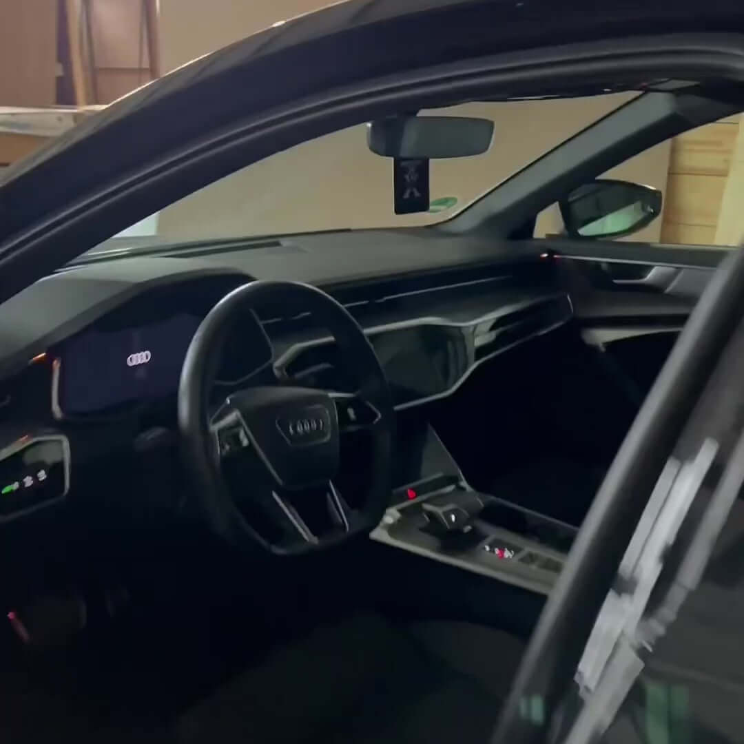 Interior view of an Audi car showcasing a modern dashboard and steering wheel design.