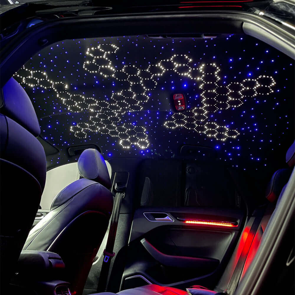 Car interior viewed from the rear seat, featuring a custom starlight headliner kit with a unique blue and white honeycomb and star pattern made from fiber optic lights