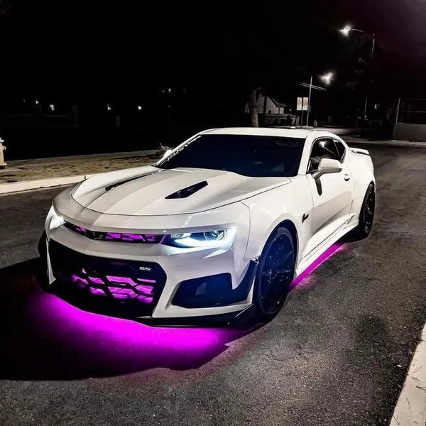 White sports car with purple lighting on a dark street under-body RGB lights/underglow fast and furious lights 