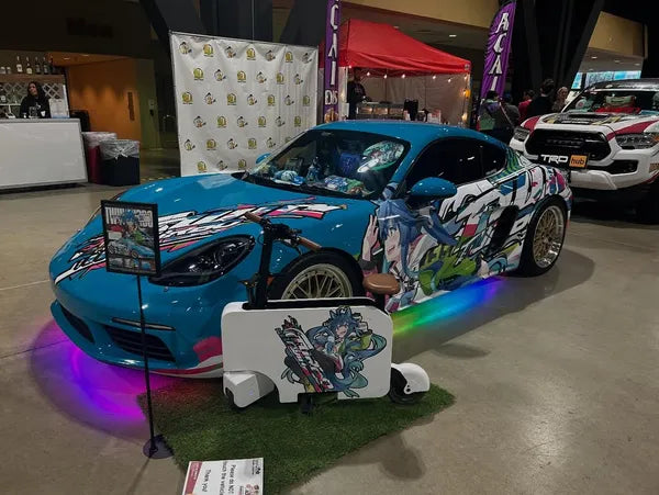 Colorful porsche with cartoon design on a stand in an indoor setting under-body RGB lights/underglow fast and furious lights 
